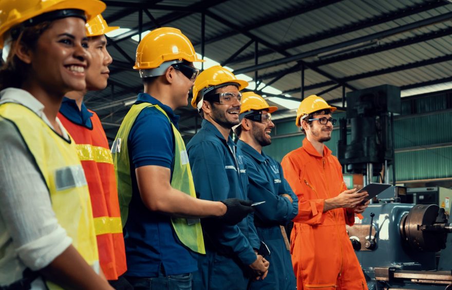Skillful worker attending brief meeting in the factory . Industrial people and manufacturing labor concept .